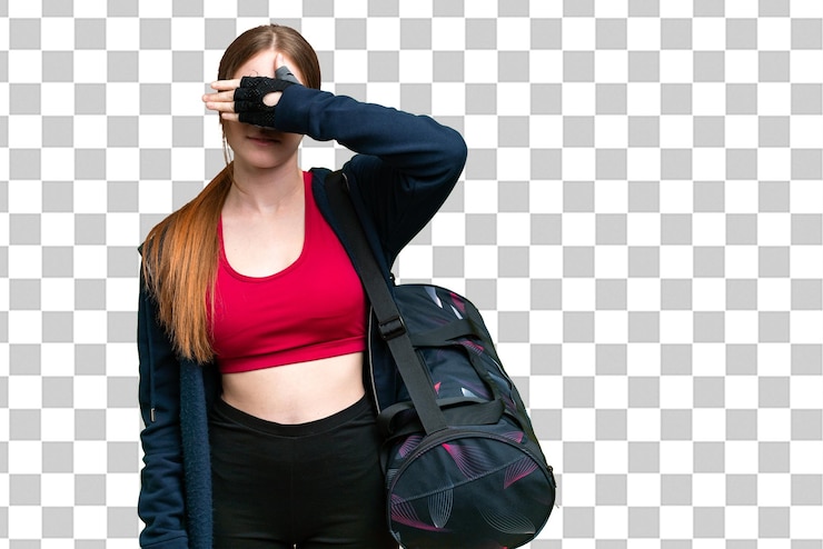 PSD jovem mulher esportiva com bolsa esportiva sobre fundo croma isolado cobrindo os olhos pelas mãos não quer ver algo