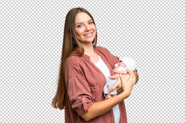 Jovem mulher loira com seu bebê recém-nascido sobre fundo croma chave isolado sorrindo muito