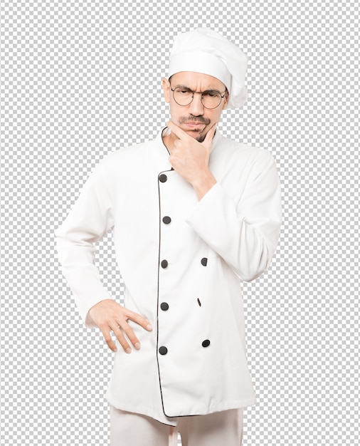 Joven chef preocupado haciendo un gesto de duda
