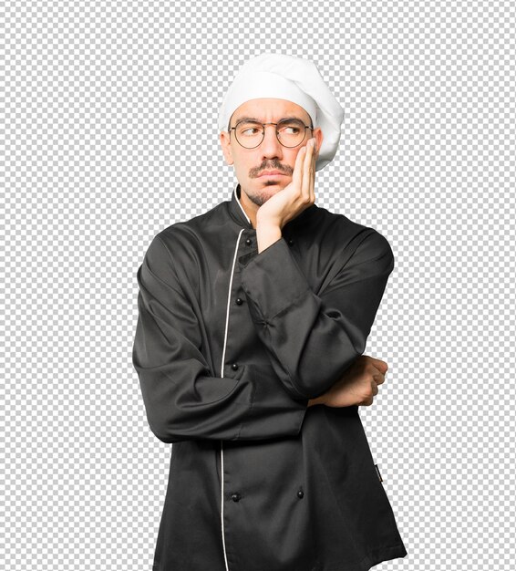Joven chef preocupado haciendo un gesto de duda