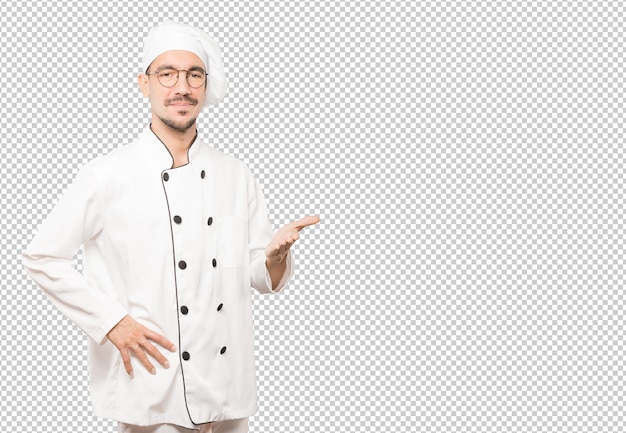 Joven chef saludando con la mano