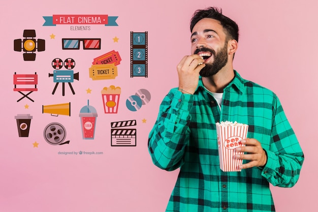 Joven comiendo palomitas de maíz junto a elementos de cine