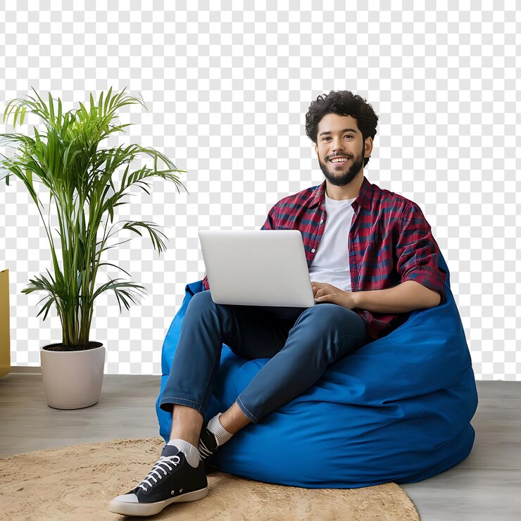 PSD joven feliz sentado en una silla de bolsa usando una nueva computadora portátil