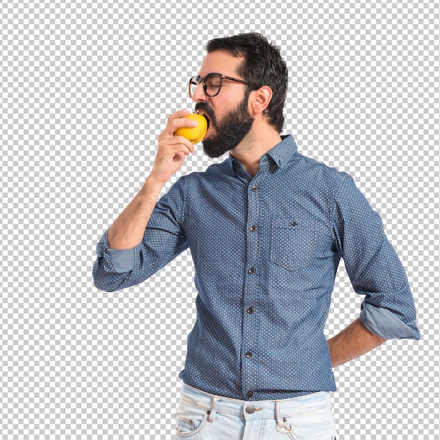 Joven hombre comiendo manzana sobre fondo blanco