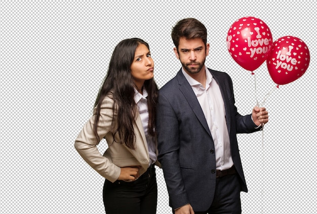 Joven pareja en el día de San Valentín regañando a alguien muy enojado