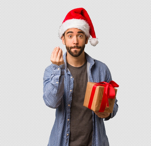 Joven con sombrero de santa haciendo un gesto típico italiano