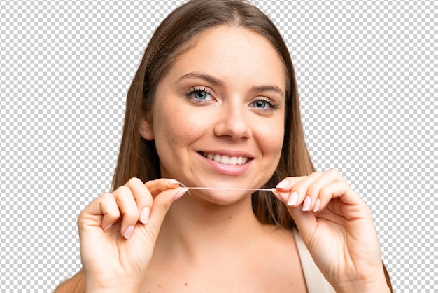 Junge blonde Frau über isolierter Chroma-Schlüssel-Hintergrund mit Zahnseide Close-up-Porträt