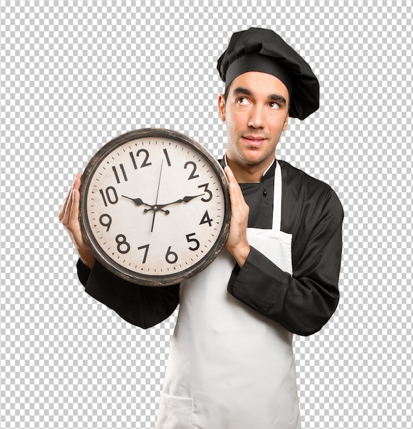 Junger chef, der eine uhr anhält