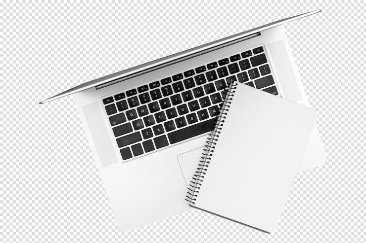 PSD laptop and blank notepad on a blue background top view with transparent wallpaper