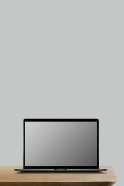 Laptop con una maqueta de pantalla en una mesa de madera