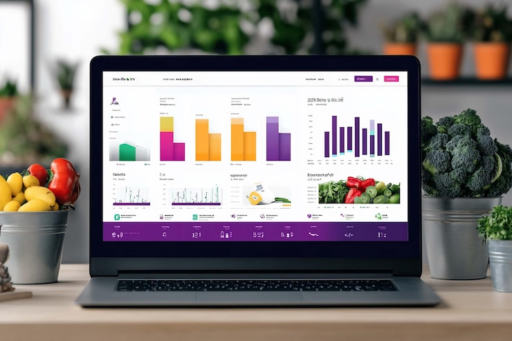 PSD laptop que muestra un tablero de instrumentos colorido con varios gráficos y gráficos potencialmente para el seguimiento de alimentos saludables o métricas de bienestar con productos frescos en primer plano