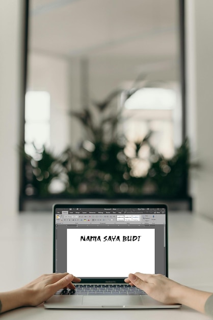 Laptop with Indonesian text NAMA SAYA BUDI