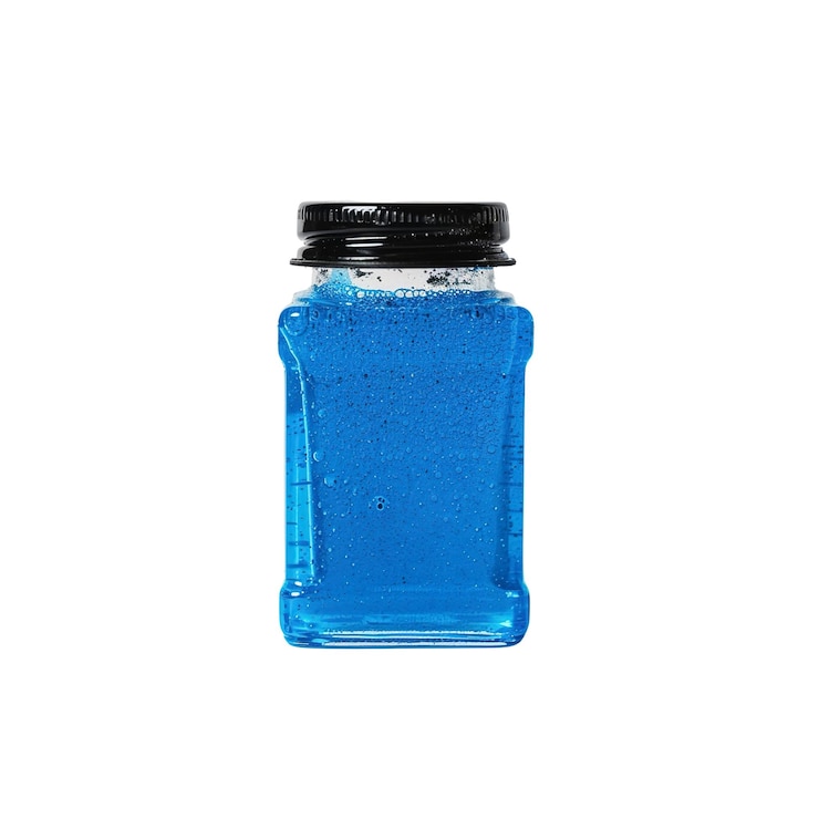 PSD líquido azul en botella de vidrio con tapa negra
