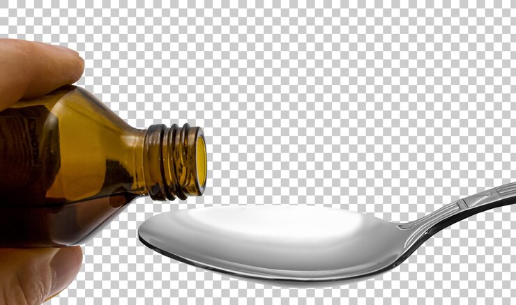 PSD líquido de uma garrafa despeje em uma colher conceito de medicamento isolado em fundo transparente