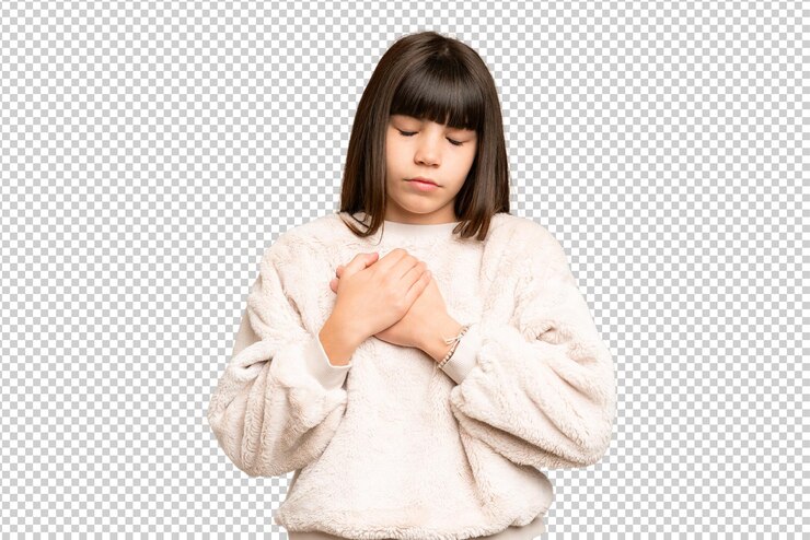 PSD little girl over isolated green chroma key background having a pain in the heart