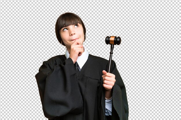 Little girl playing as a Judge over isolated background and looking up