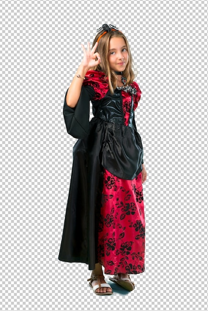 PSD loira criança vestida como um vampiro para as férias de halloween, mostrando um sinal de ok com os dedos