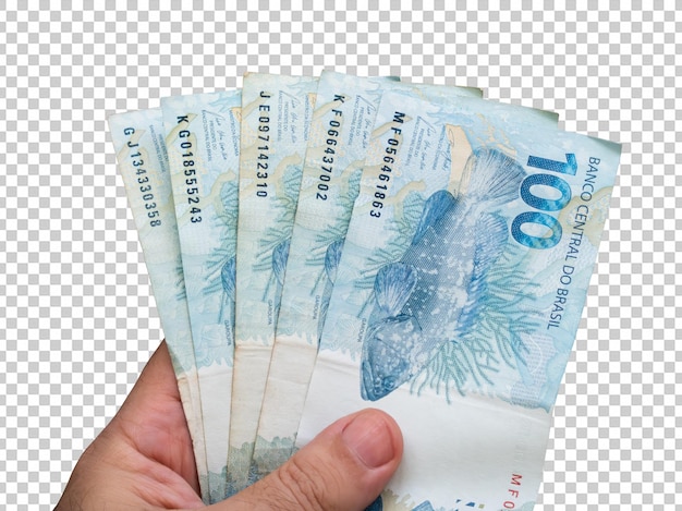 Main tenant des billets de cent reais brésiliens Concept financier Fond transparent
