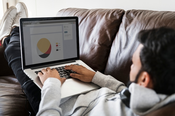 PSD man using laptop on sofa