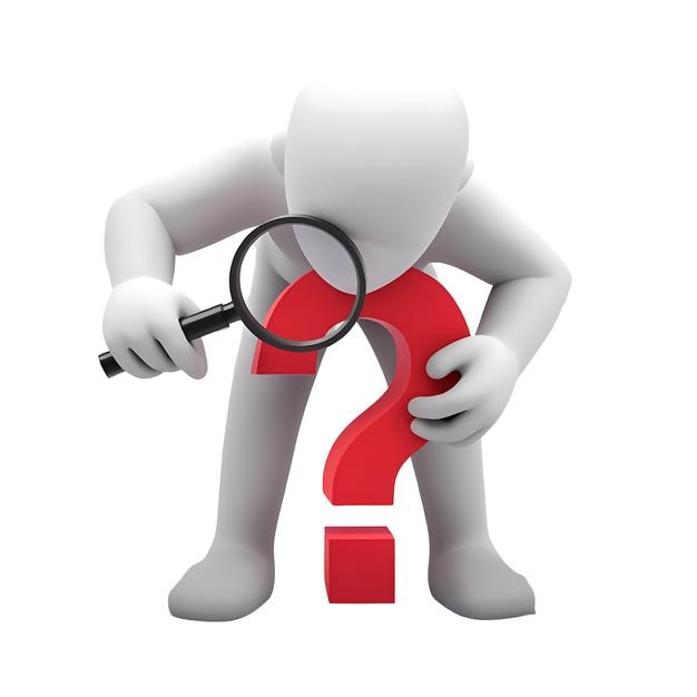 Man with magnifying glass looking at a big question mark