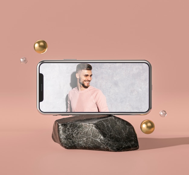 Maqueta 3d de teléfono móvil sobre roca de mármol