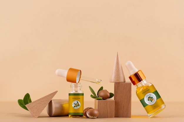 Maqueta de botella cosmética de aceite de argán con podio y granos en forma de madera