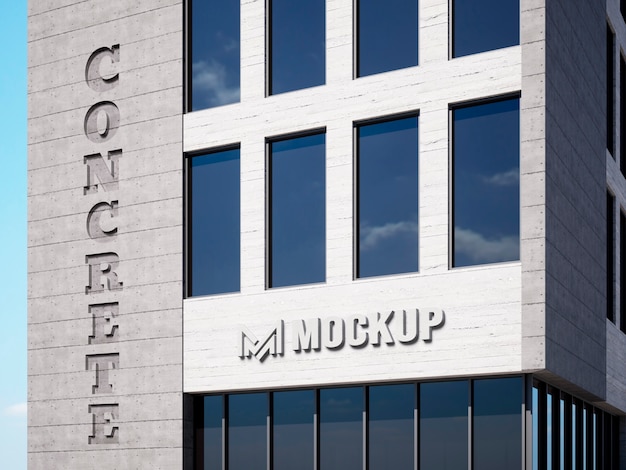 Maqueta de logo en edificio de concreto con vista al cielo