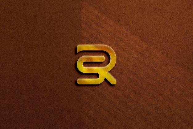 Maqueta de logotipo dorado sobre fondo texturizado con sombra