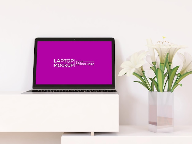 Una maqueta de pantalla de computadora portátil con un jarrón de flores en el fondo