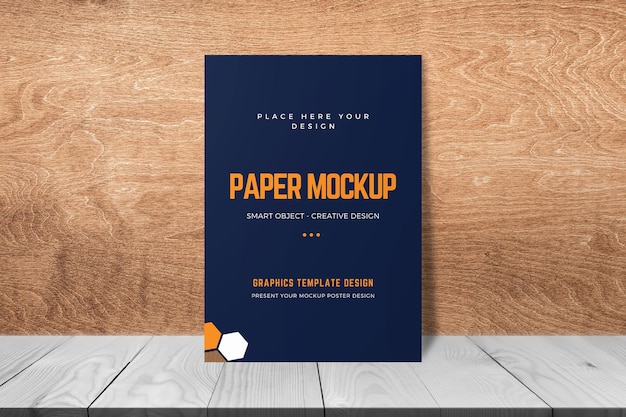 Maqueta de papel A4 apoyada en la pared de madera TBackground