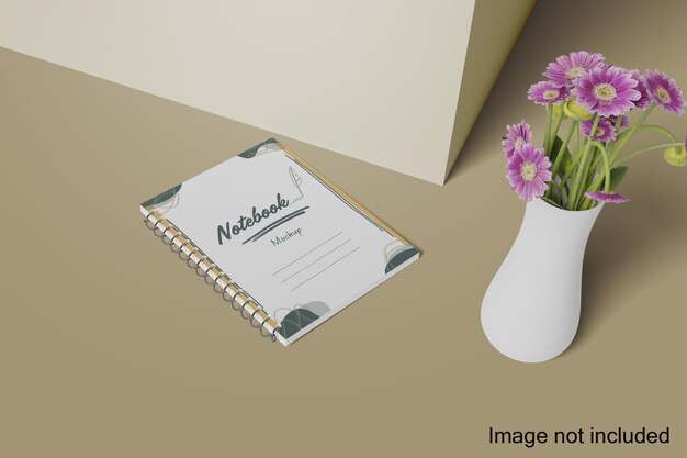 Una maqueta realista de cuaderno está en el suelo cerca de la pared