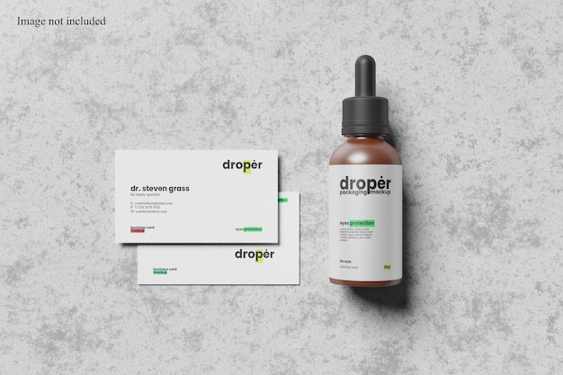 Maqueta de tarjeta de presentación con vista superior y botella cuentagotas para mostrar su diseño a los clientes