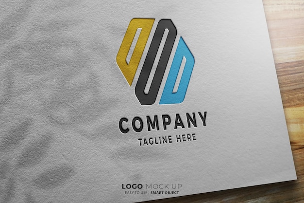 Maquete de logotipo colorido moderno gravado em fundo branco e madeira