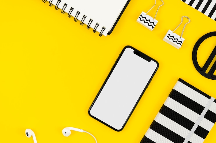 PSD maquete de telefone com vista superior com bloco de notas e fones de ouvido