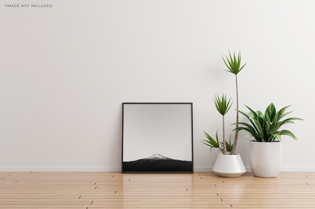 Maquete quadrada preta da moldura da foto em um quarto vazio de parede branca com plantas no chão de madeira