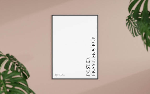 Maquette de photo ou de cadre d'affiche noir vertical vue de face propre et minimaliste accrochée au mur avec un rendu 3d de plante floue