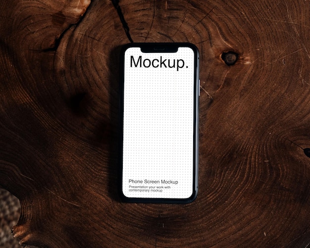 Maquette de smartphone avec fond en bois