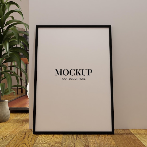 Minimalistisches Poster-Attrappenrahmen auf dem Boden, an die weiße Wand gelehnt, mit Pflanze als Dekoration