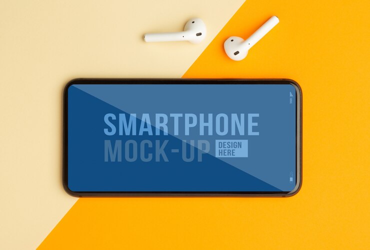 Mise à plat, vue de dessus du bureau de table de bureau orange avec modèle de maquette de smartphone pour votre conception et vos écouteurs sans fil. Espace de travail moderne