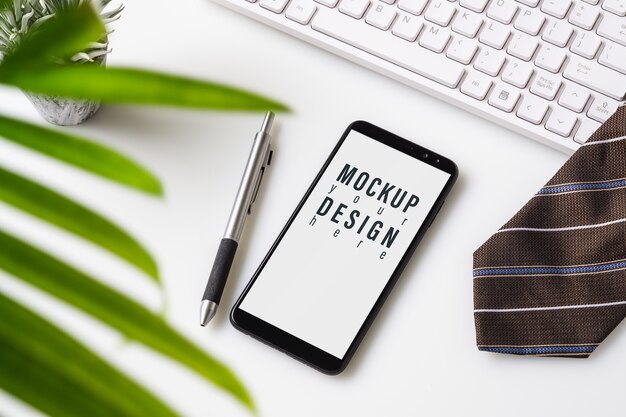 PSD mock-up-smartphone. draufsicht der schreibtischtabelle mit diagrammdiagramm.