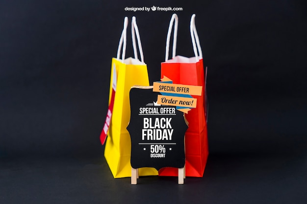 PSD mockup de black friday con dos bolsas detrás de tabla