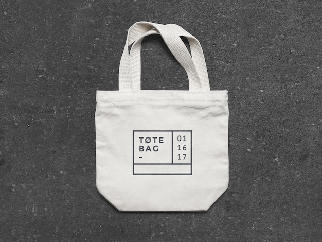 Mockup de bolsa de Tote blanca minimalista en una superficie oscura