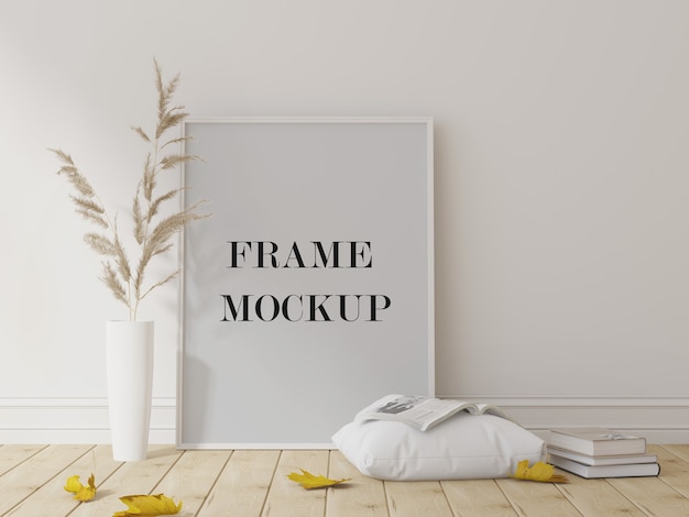 Mockup di cornice bianca accanto a piante secche e foglie