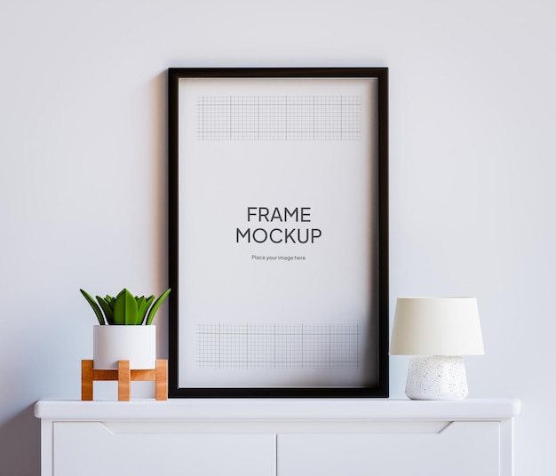 Mockup di cornice per foto PSD sul tavolo con piante e luci Soggiorno decorazione parete bianca