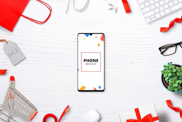 Mockup di telefono sulla scrivania con articoli per lo shopping