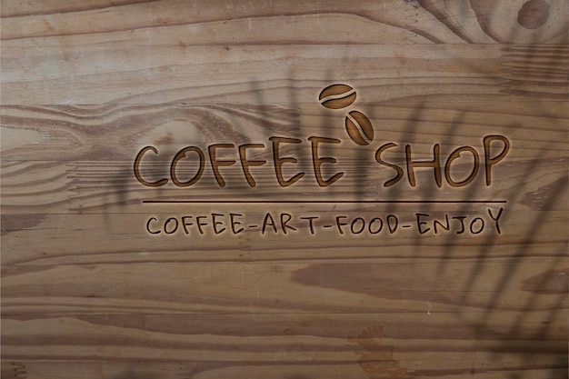 Mockup del logotipo de Deboss psd para café sobre fondo de textura de madera