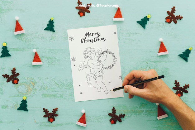 PSD mockup de navidad con mano dibujando