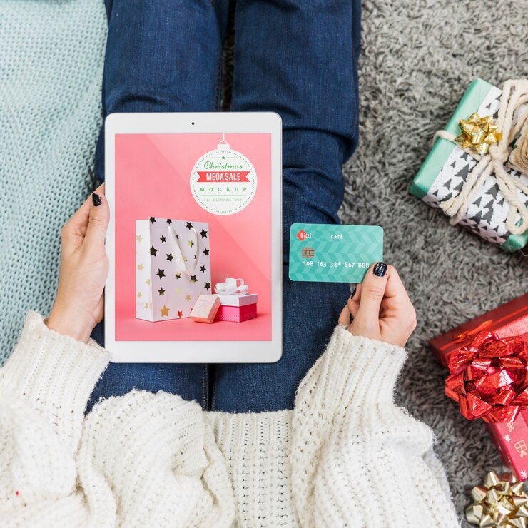 PSD mockup de rebajas de navidad con mujer usando tableta