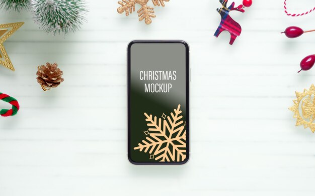 Mockup de téléphone portable intelligent pour Noël et le Nouvel An à l'arrière-plan
