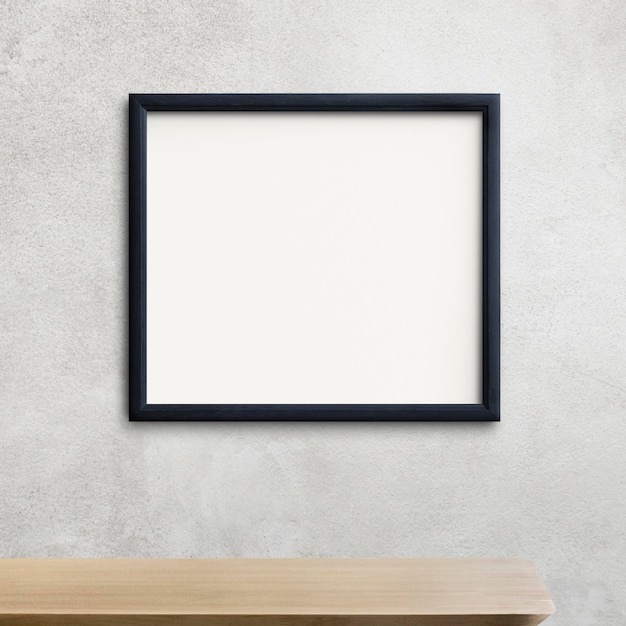 Modèle de cadre noir sur un mur gris